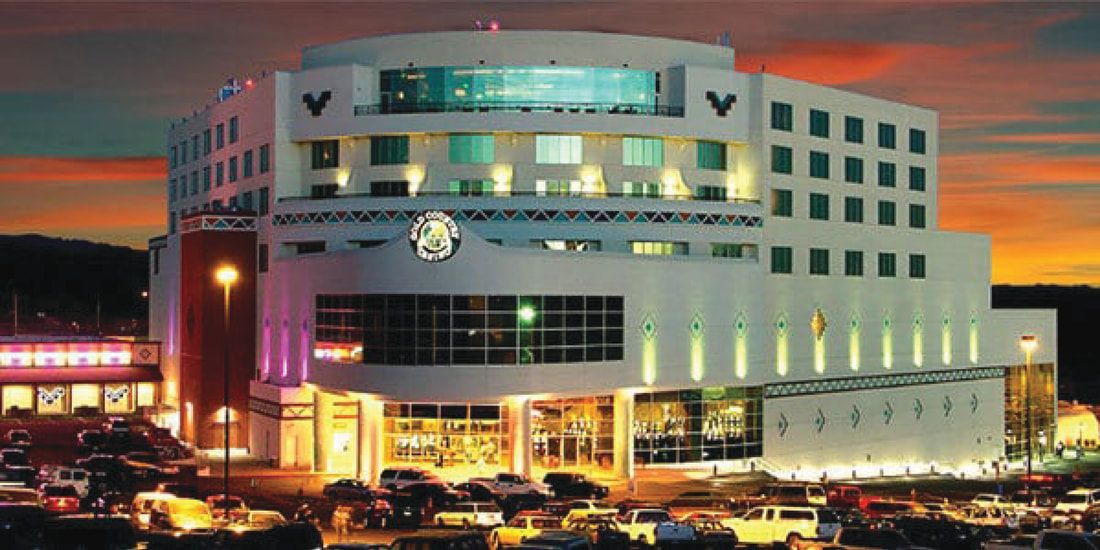 A large building with a lot of windows is lit up at night.