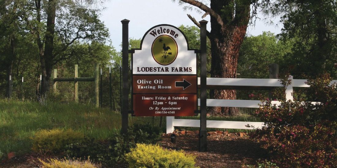 A sign for lordstar farms is in front of a white fence