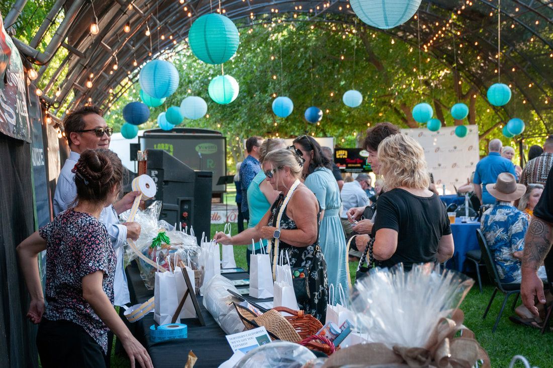 A group of people are standing around a table at a party.