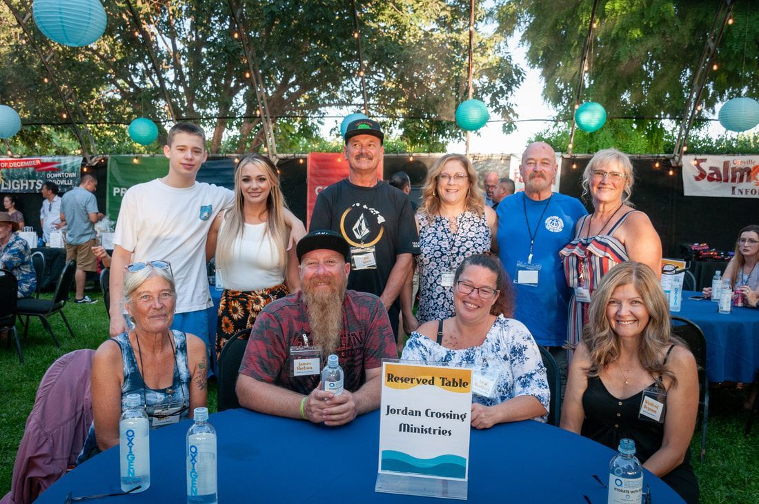 A group of people are posing for a picture at a table.