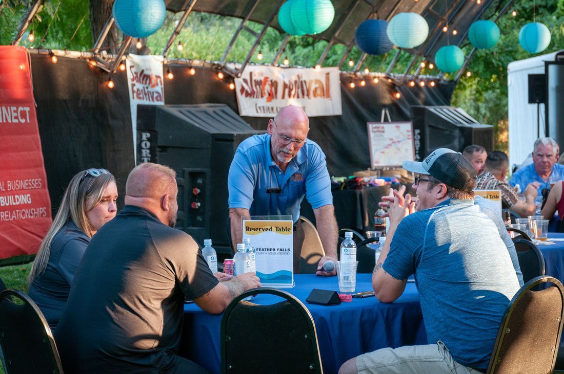 A group of people are sitting around a table at a party.