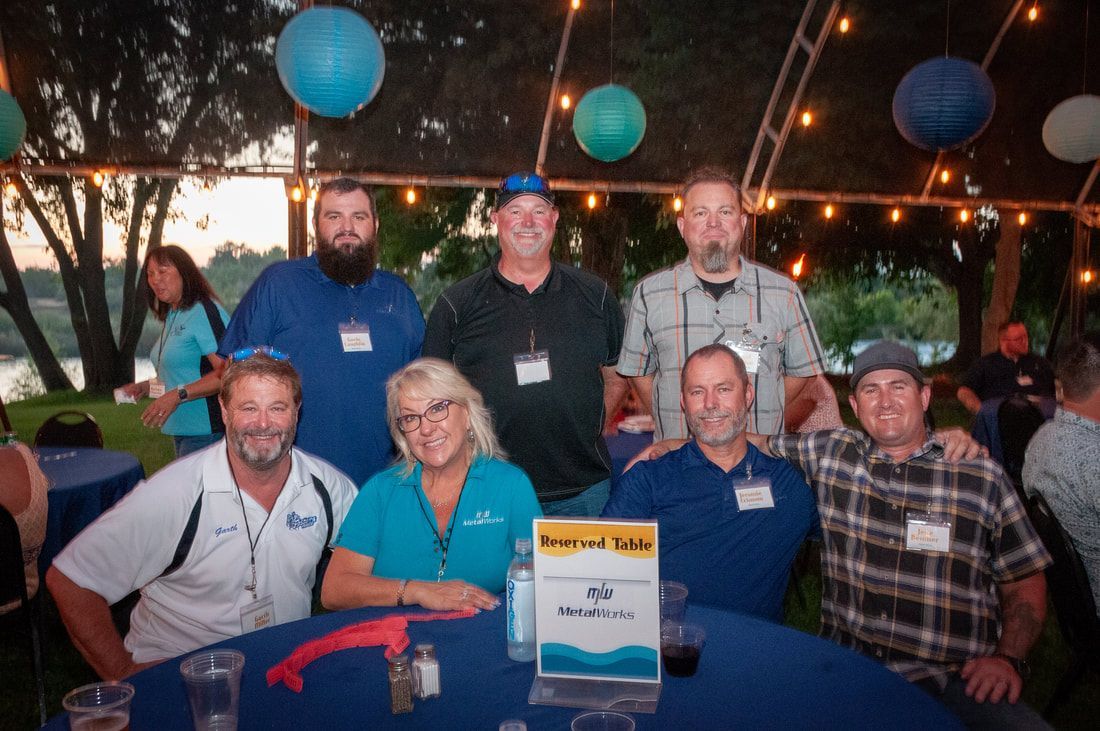 A group of people are posing for a picture at a table.