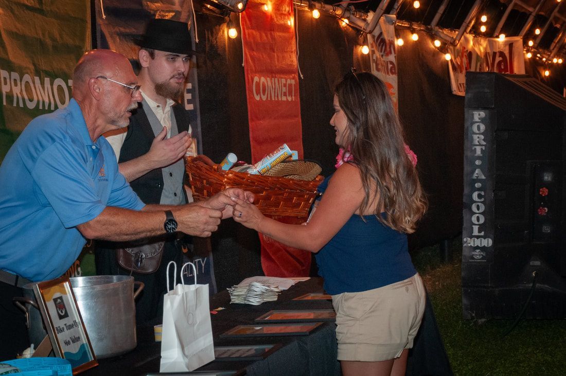 A man and woman shaking hands in front of a sign that says porta cool