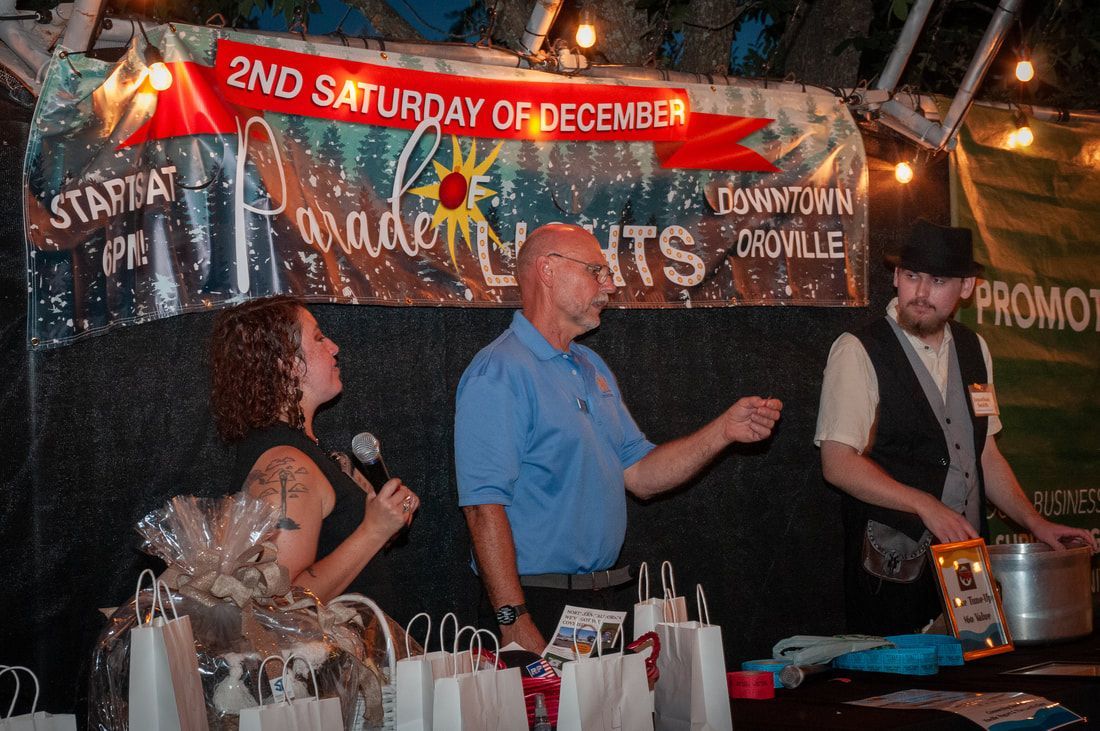 A group of people standing in front of a sign that says 2nd saturday of december