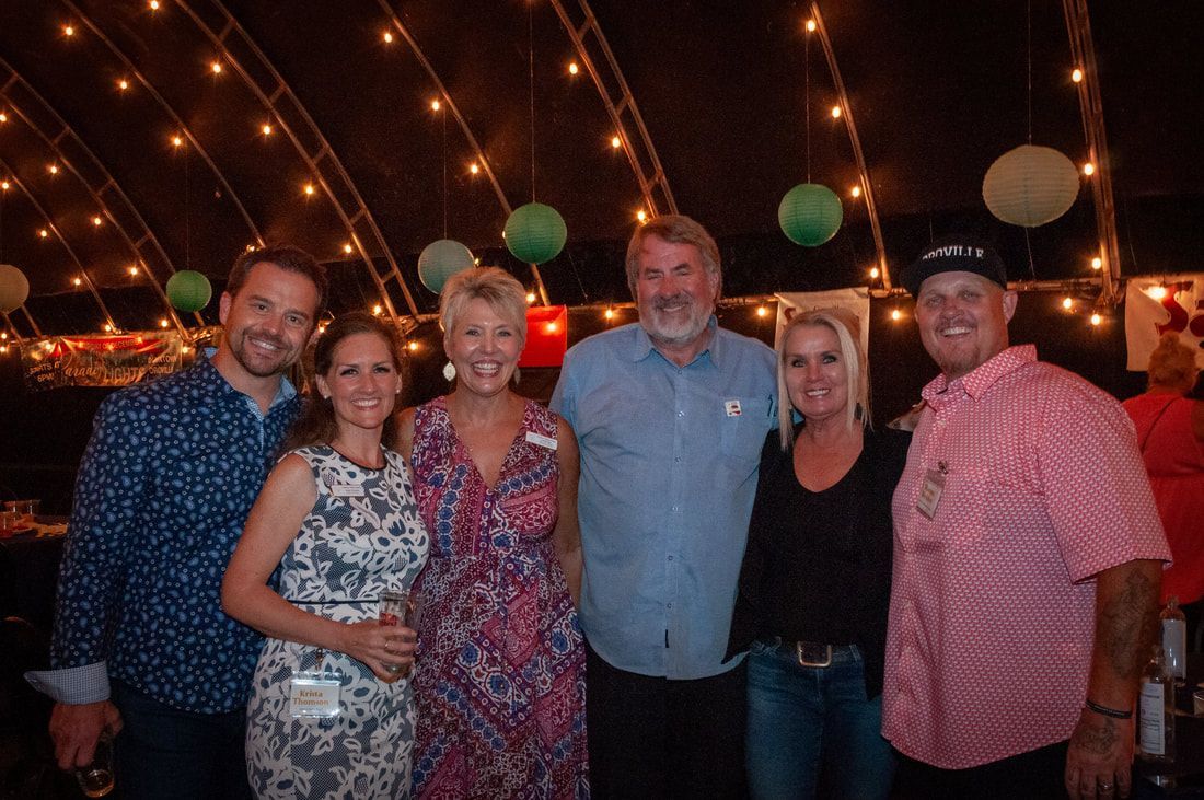 A group of people are posing for a picture at a party.