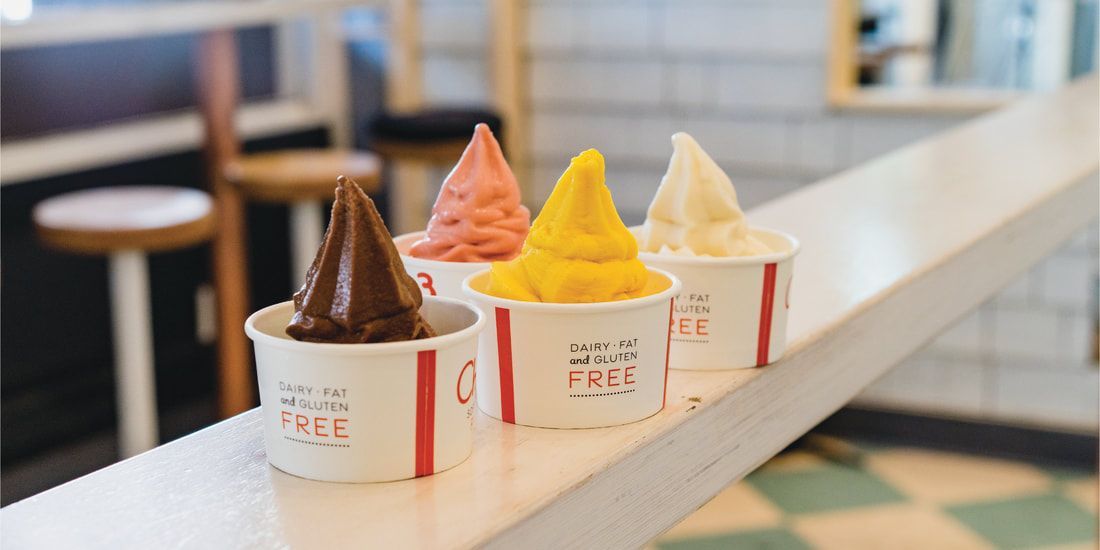 Four cups of ice cream are sitting on a counter.