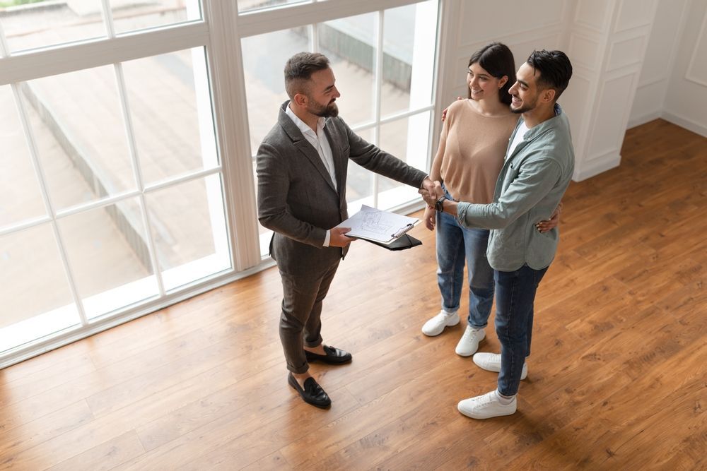 Couple Buying A House With Salesperson — MoneySmith Group In Kingscliff, NSW