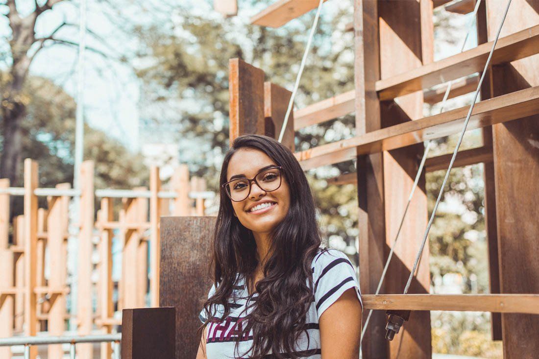 Young Woman Wearing Glasses is Smiling — MoneySmith Group In Kingscliff, NSW