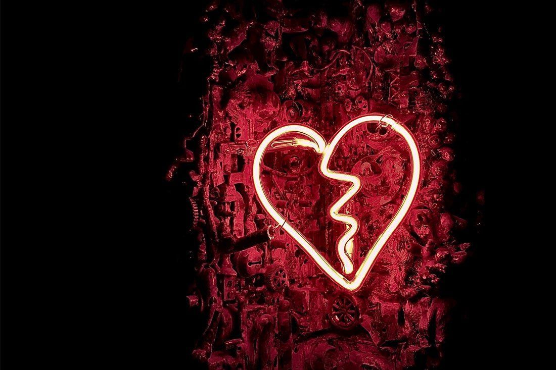 Neon Sign of a Broken Heart on a Red Background — MoneySmith Group In Kingscliff, NSW