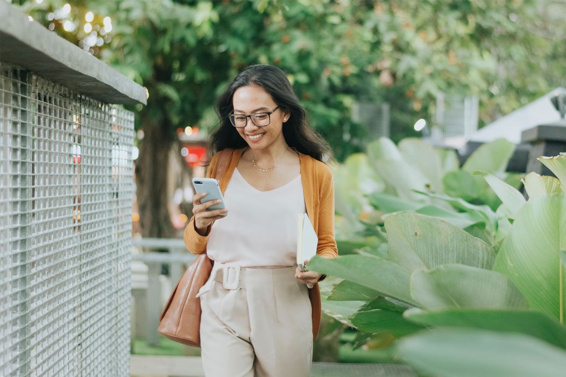 A Woman is Walking Down a Sidewalk — MoneySmith Group In Kingscliff, NSW