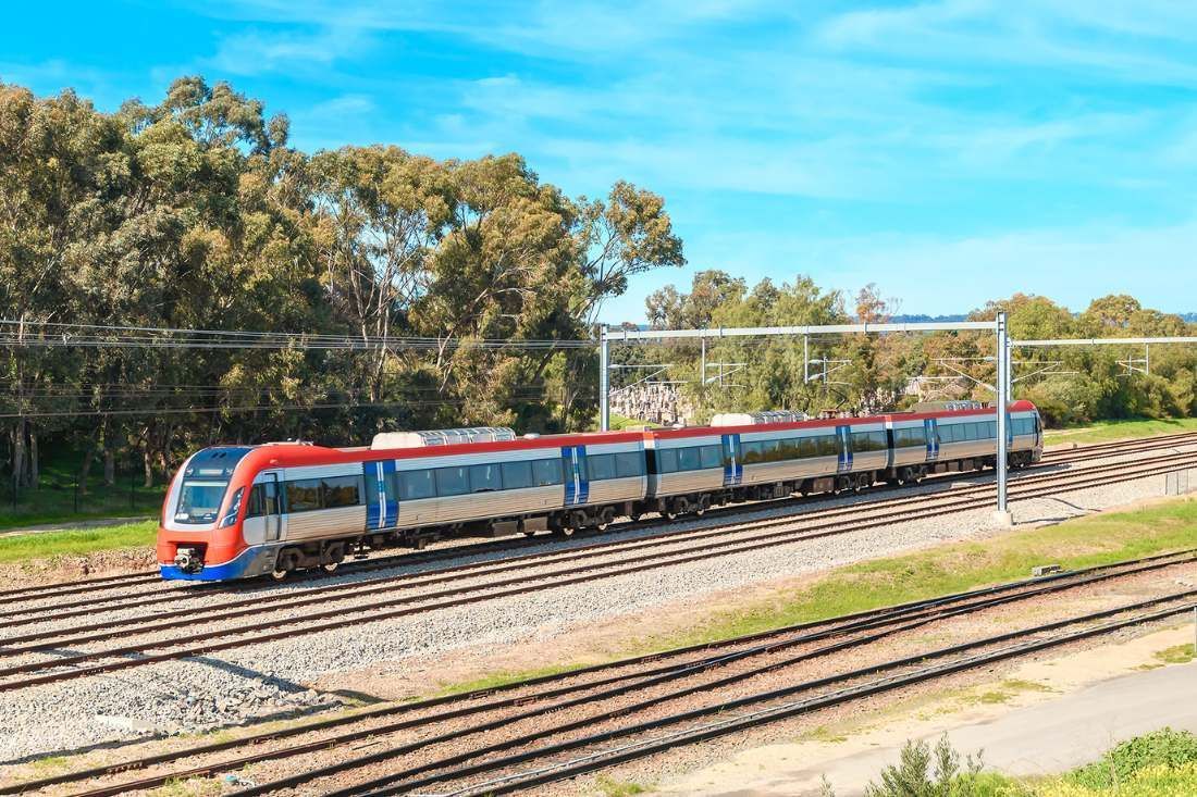 A Red And Blue Train Is Going Down Train Tracks — MoneySmith Group In Kingscliff, NSW