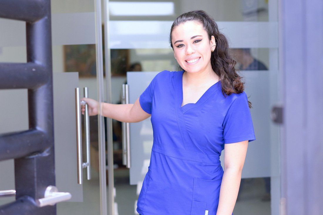 Woman in a Blue Scrub Top is Standing — MoneySmith Group In Kingscliff, NSW