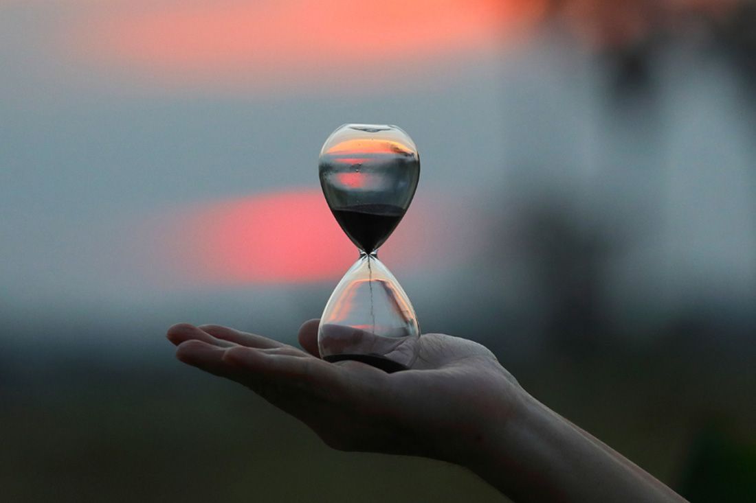 A Person is Holding an Hourglass in Their Hand — MoneySmith Group In Kingscliff, NSW
