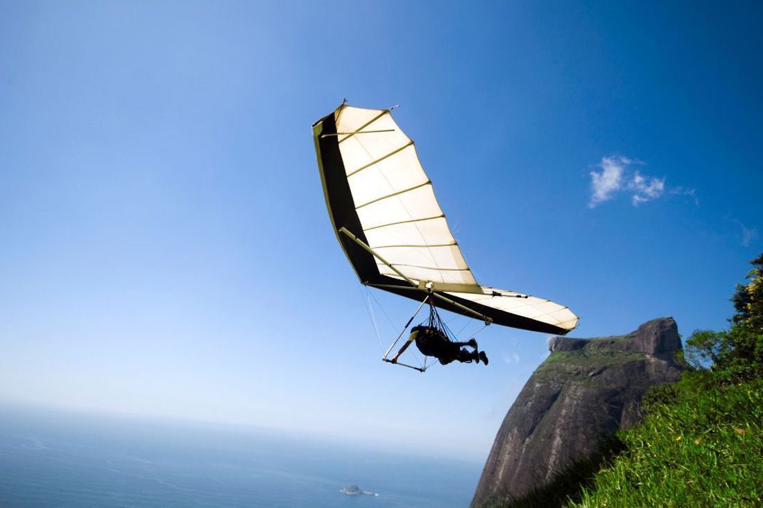 A Person is Flying a Hang Glider Over a Mountain — MoneySmith Group In Kingscliff, NSW