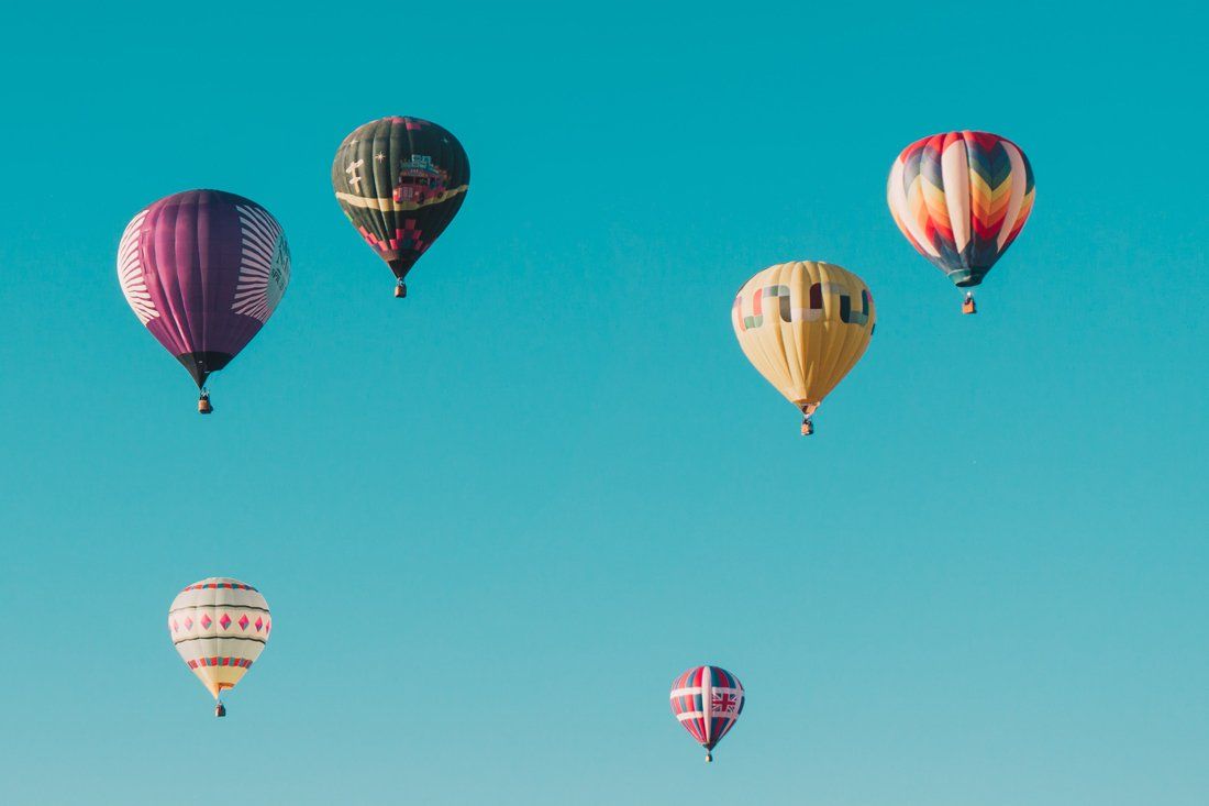Group of Hot Air Balloons Are Flying in a Blue Sky — MoneySmith Group In Kingscliff, NSW