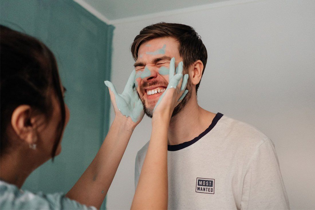 Woman is Putting a Mask on a Man's Face — MoneySmith Group In Kingscliff, NSW