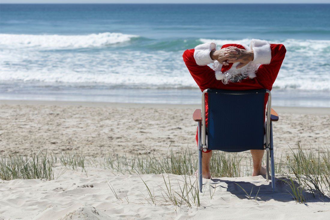 Man Dressed as Santa Claus is Sitting in a Beach Chair — MoneySmith Group In Kingscliff, NSW