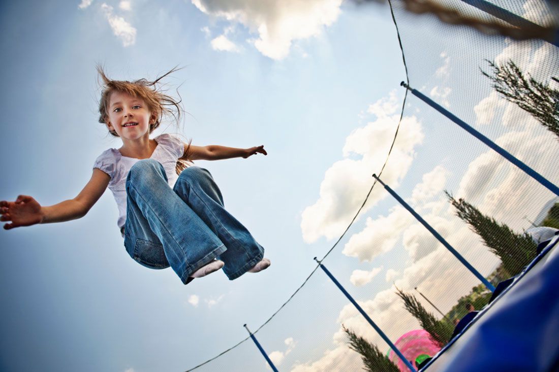 A Young Girl is Jumping on a Trampoline — MoneySmith Group In Kingscliff, NSW