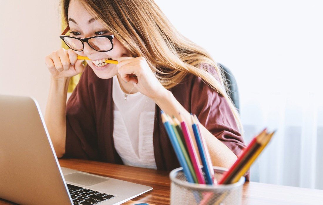 A Woman is Sitting at a Desk — MoneySmith Group In Kingscliff, NSW