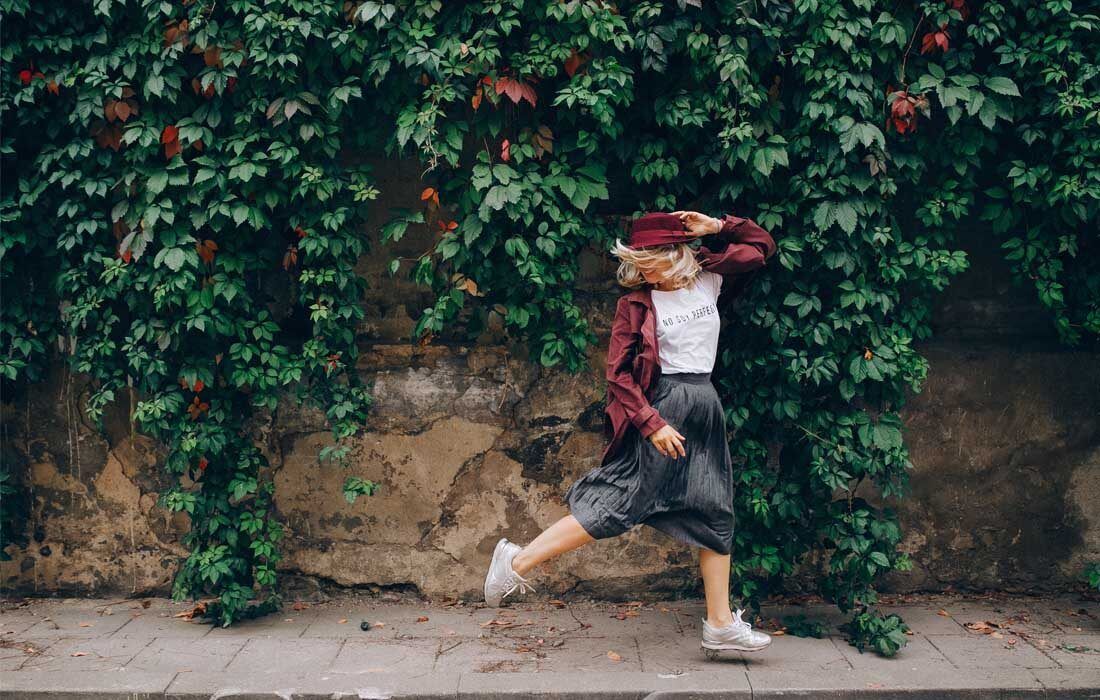 Woman is Running in Front of a Ivy Covered Wall — MoneySmith Group In Kingscliff, NSW