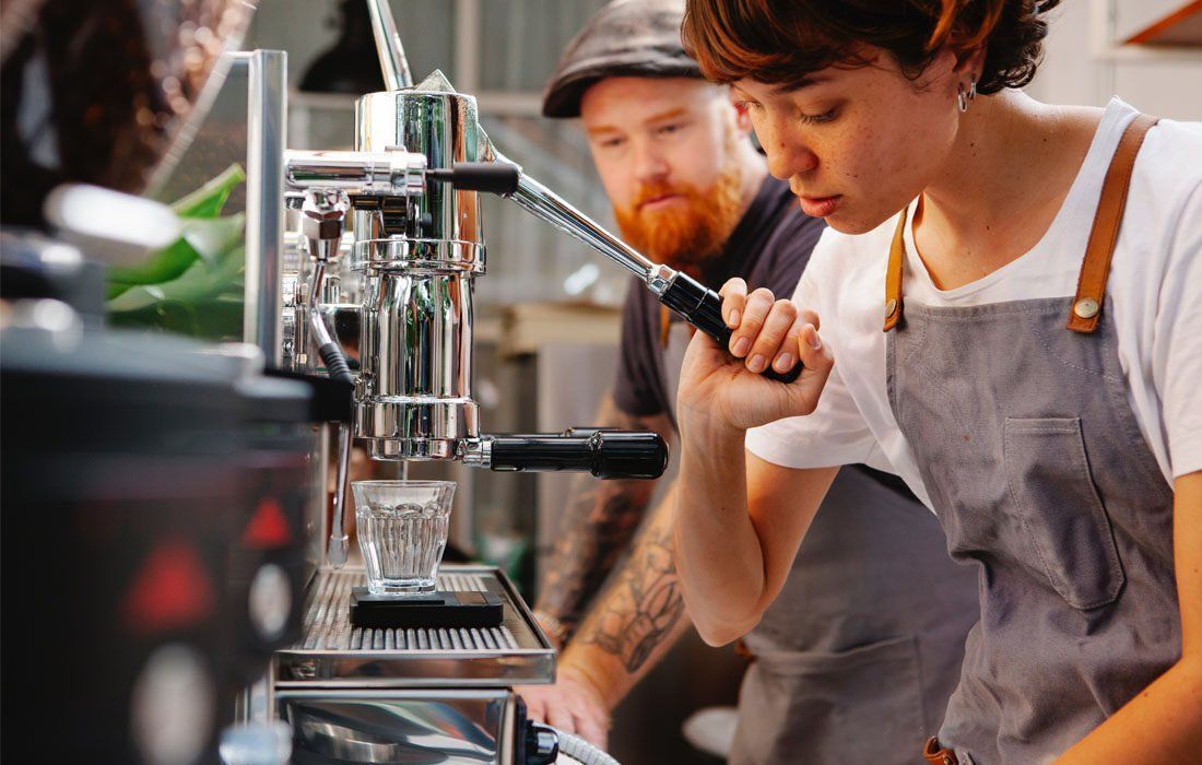 Man and a Woman Are Making Coffee — MoneySmith Group In Kingscliff, NSW