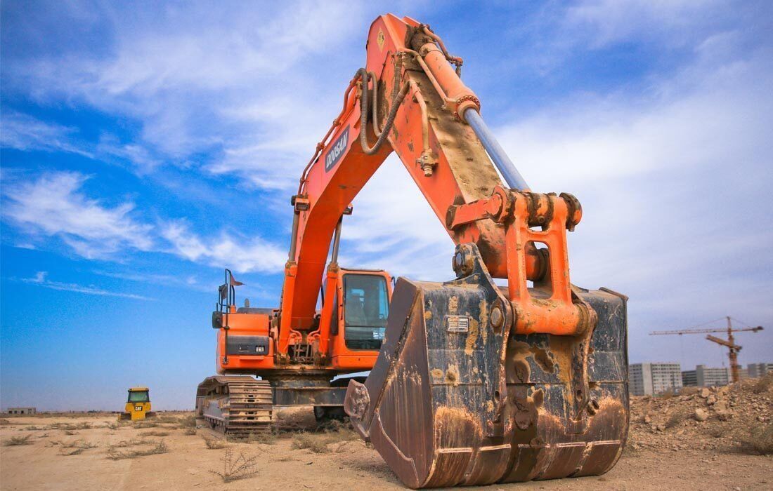 Large Orange Excavator — MoneySmith Group In Kingscliff, NSW