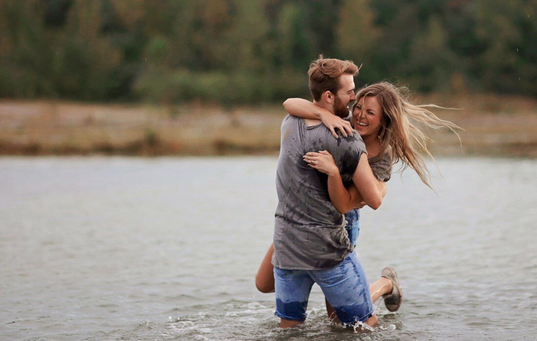 A Man is Holding a Woman in His Arms — MoneySmith Group In Kingscliff, NSW