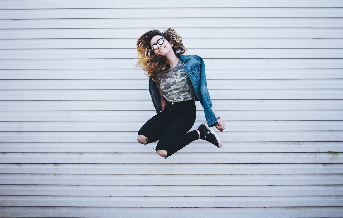 A Woman is Jumping in the Air — MoneySmith Group In Kingscliff, NSW