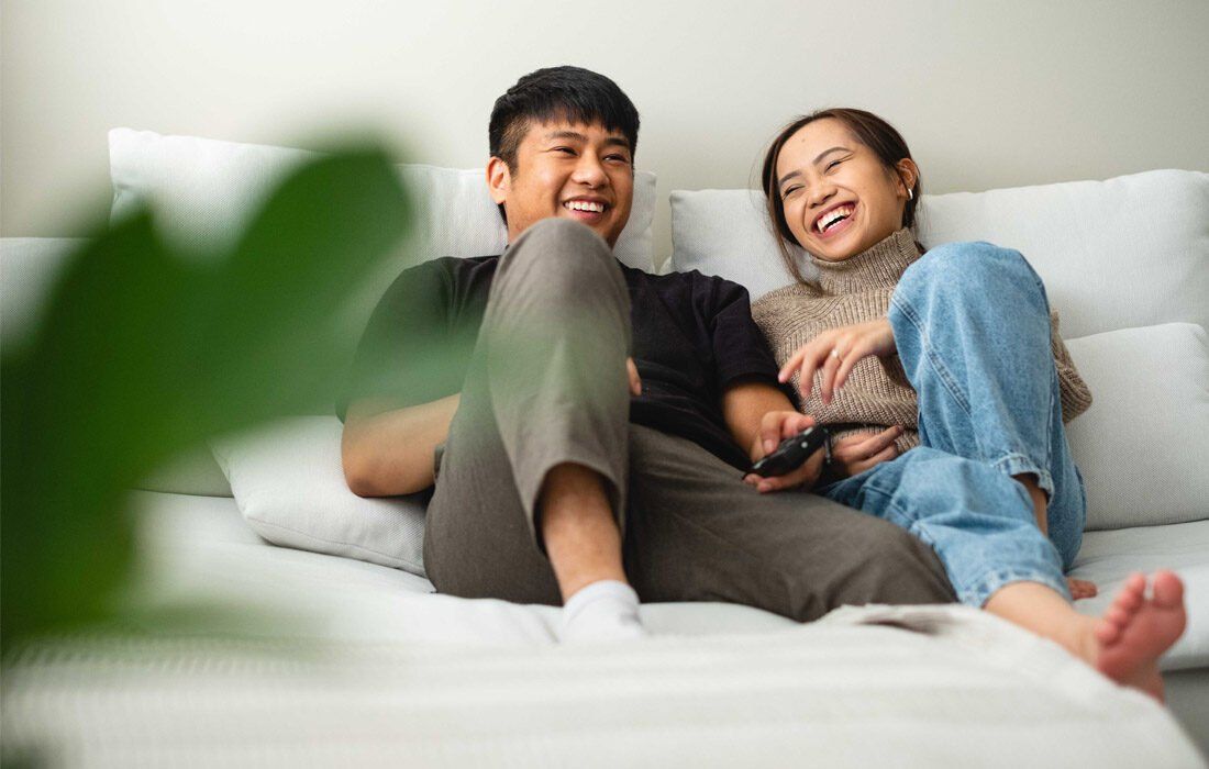 A Man and a Woman Are Sitting on a Couch — MoneySmith Group In Kingscliff, NSW