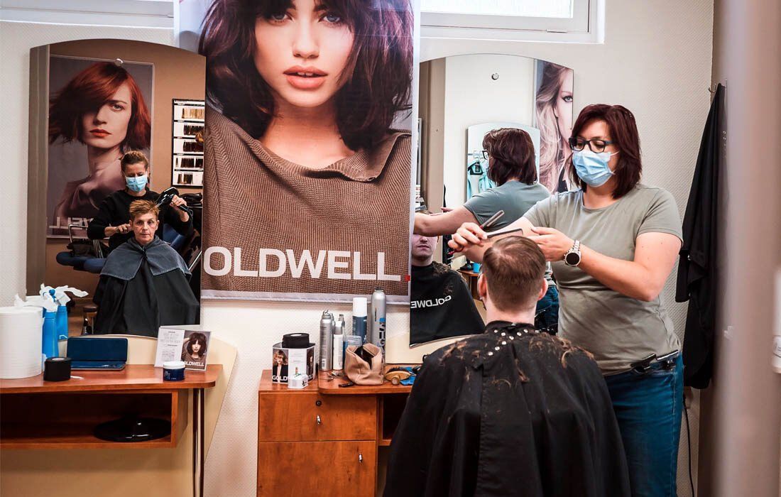 A Woman is Cutting a Man 's Hair — MoneySmith Group In Kingscliff, NSW