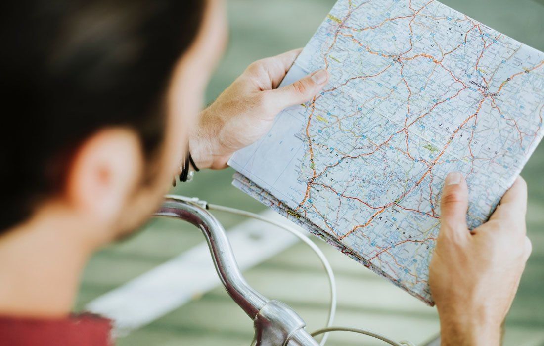 A Man is Riding a Bike and Looking at a Map — MoneySmith Group In Kingscliff, NSW