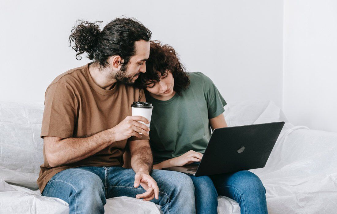 Man and a Woman Are Sitting on a Couch — MoneySmith Group In Kingscliff, NSW
