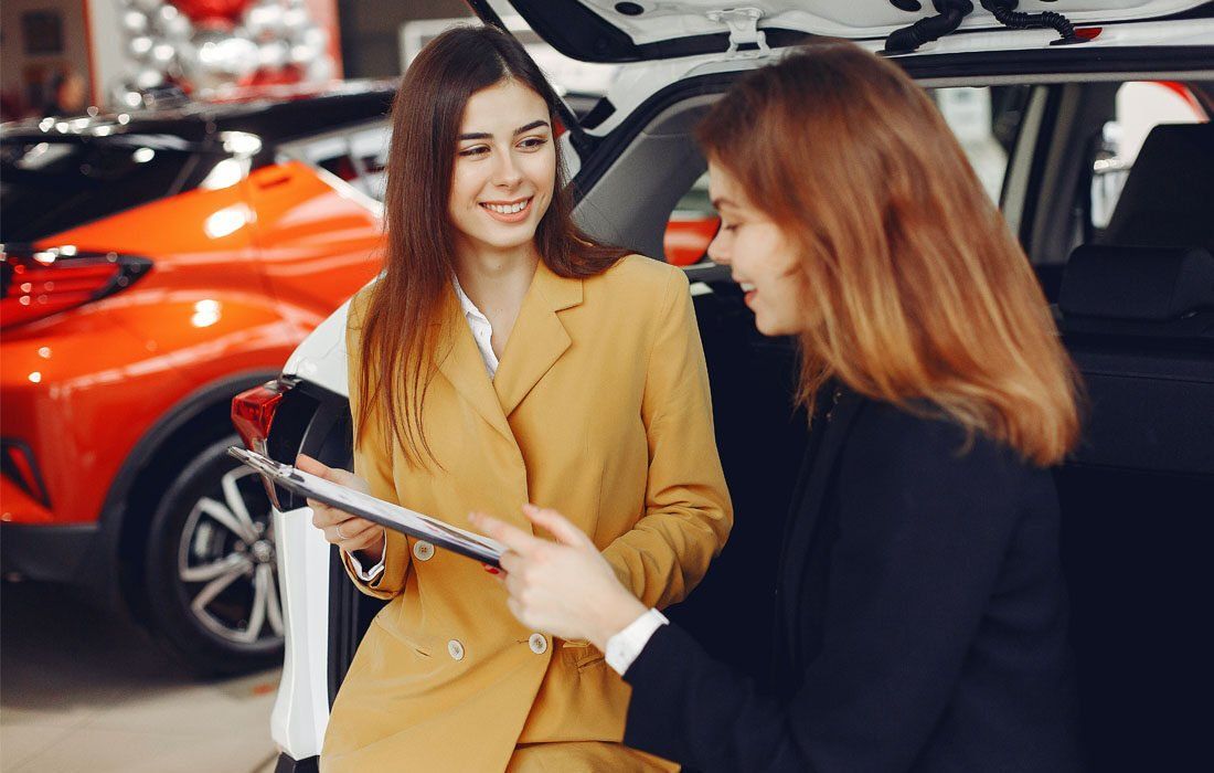 Two Women in a Car Showroom — MoneySmith Group In Kingscliff, NSW