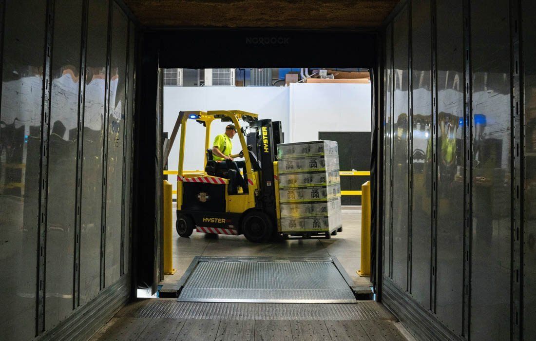 A Man is Driving a Forklift — MoneySmith Group In Kingscliff, NSW