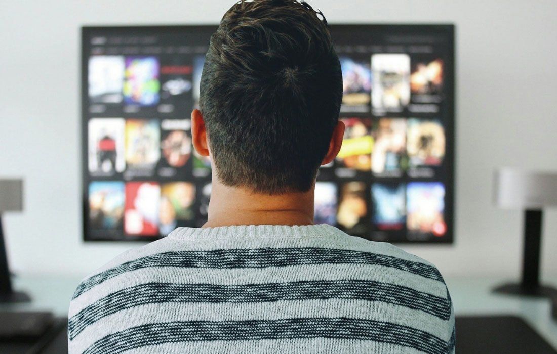 A Man is Sitting in Front of a Television — MoneySmith Group In Kingscliff, NSW