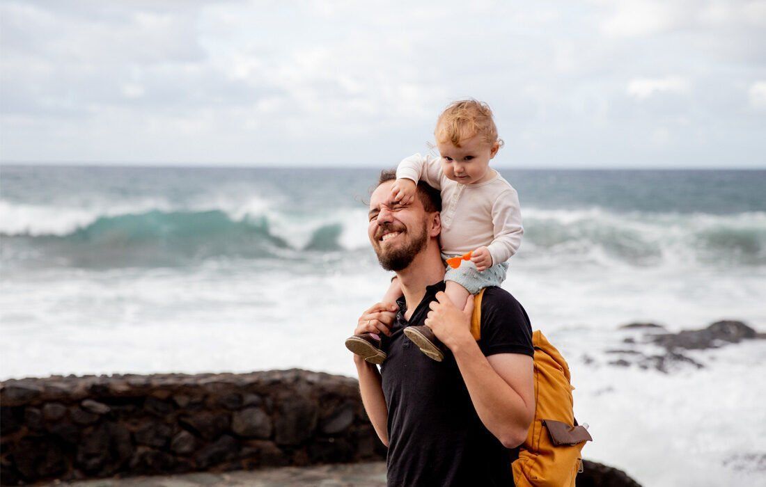 Man is Carrying a Baby on His Shoulders — MoneySmith Group In Kingscliff, NSW