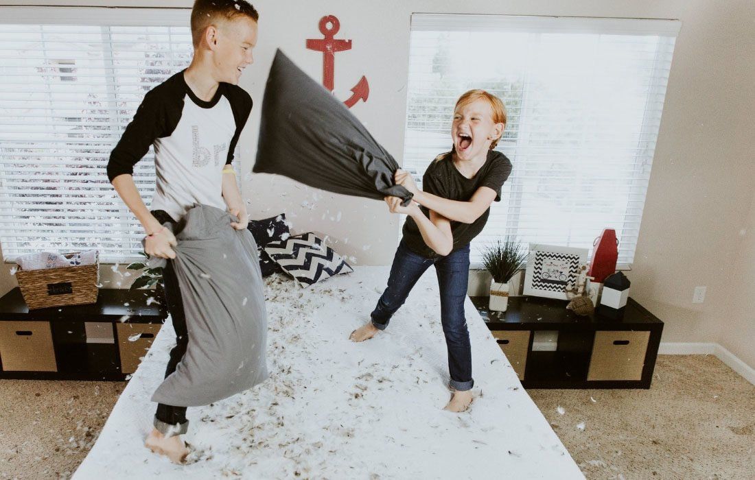 Two Children Are Having a Pillow Fight — MoneySmith Group In Kingscliff, NSW
