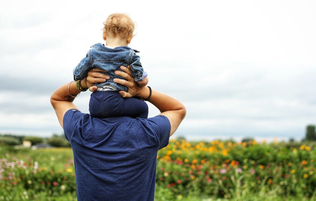A Man is Carrying a Baby on His Shoulders — MoneySmith Group In Kingscliff, NSW