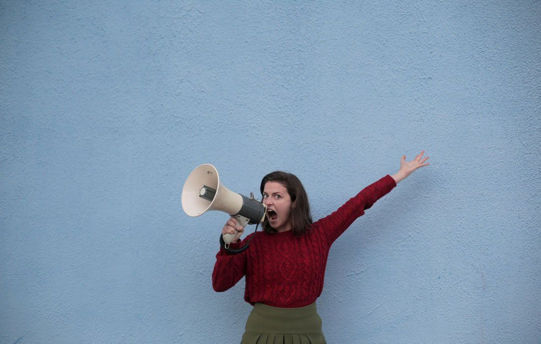 A Woman is Holding a Megaphone — MoneySmith Group In Kingscliff, NSW