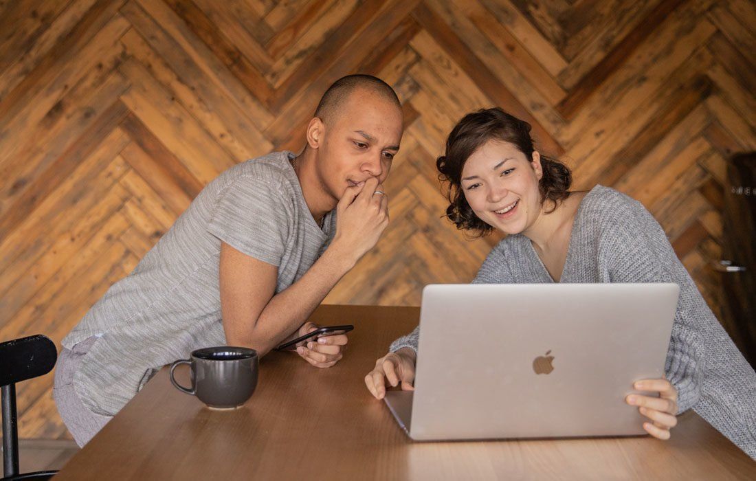 A Man and a Woman Are Sitting at a Table — MoneySmith Group In Kingscliff, NSW