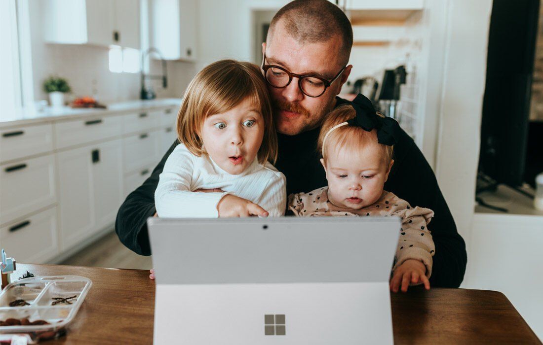 Man is Sitting at a Table With Two Children — MoneySmith Group In Kingscliff, NSW