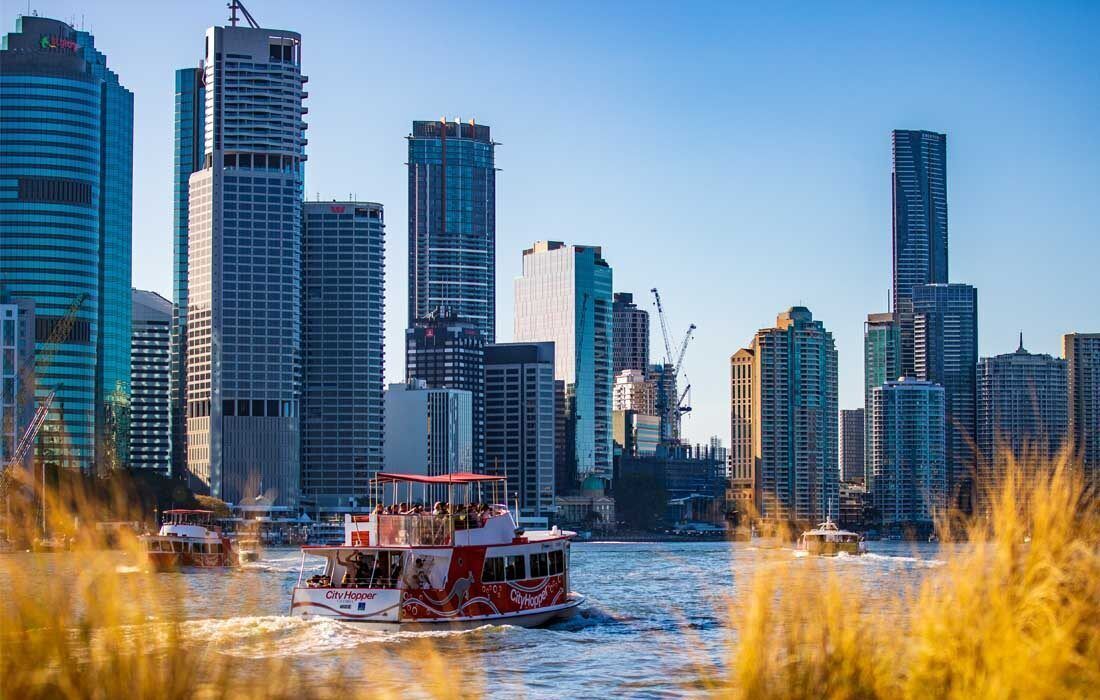 Boat is Floating on a River in Front of a City Skyline — MoneySmith Group In Kingscliff, NSW