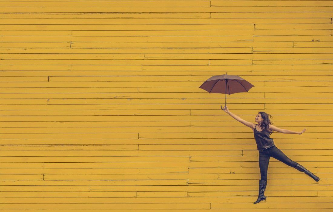 A Woman is Holding an Umbrella — MoneySmith Group In Kingscliff, NSW