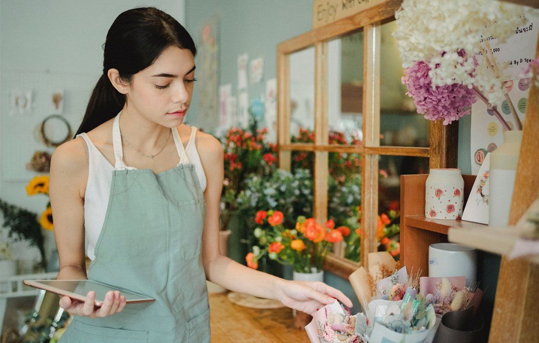 A Woman in a Flower Shop — MoneySmith Group In Kingscliff, NSW