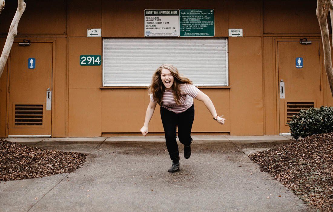 A Woman is Running in Front of a Building — MoneySmith Group In Kingscliff, NSW