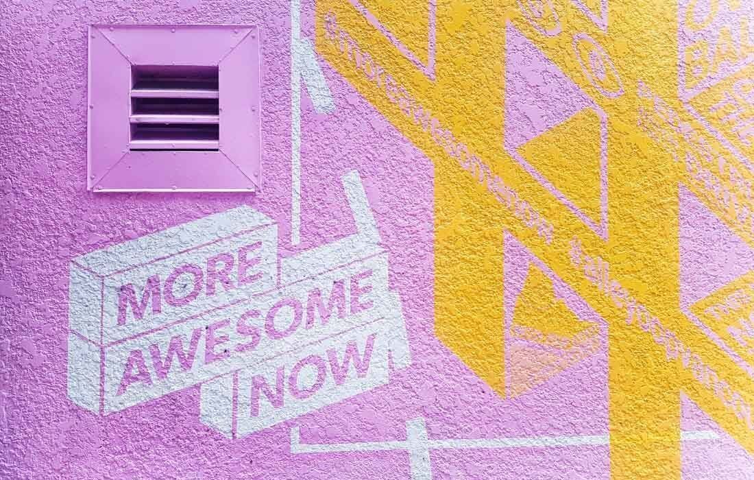 A Pink and Yellow Wall With a Sign — MoneySmith Group In Kingscliff, NSW