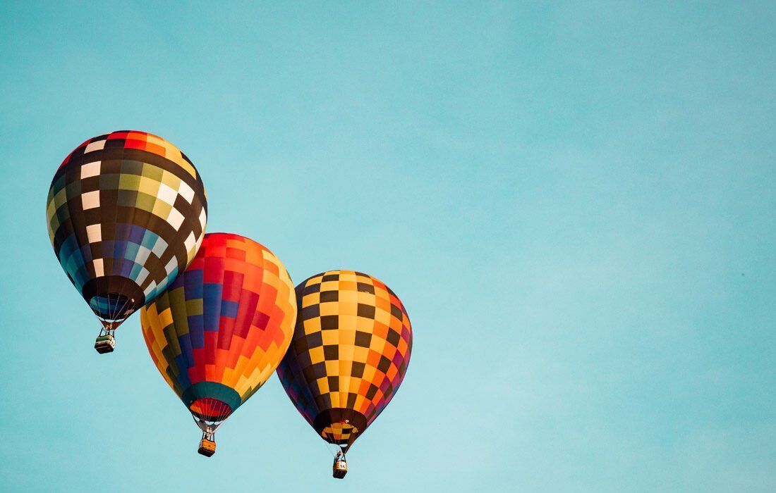 Three Colorful Hot Air Balloons Are Flying in a Blue Sky — MoneySmith Group In Kingscliff, NSW