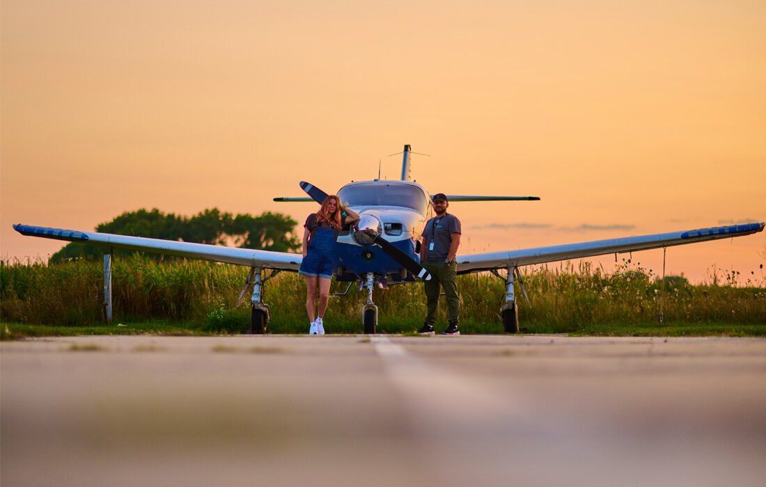 Two Persons Are Standing in Front of a Small Airplane — MoneySmith Group In Kingscliff, NSW
