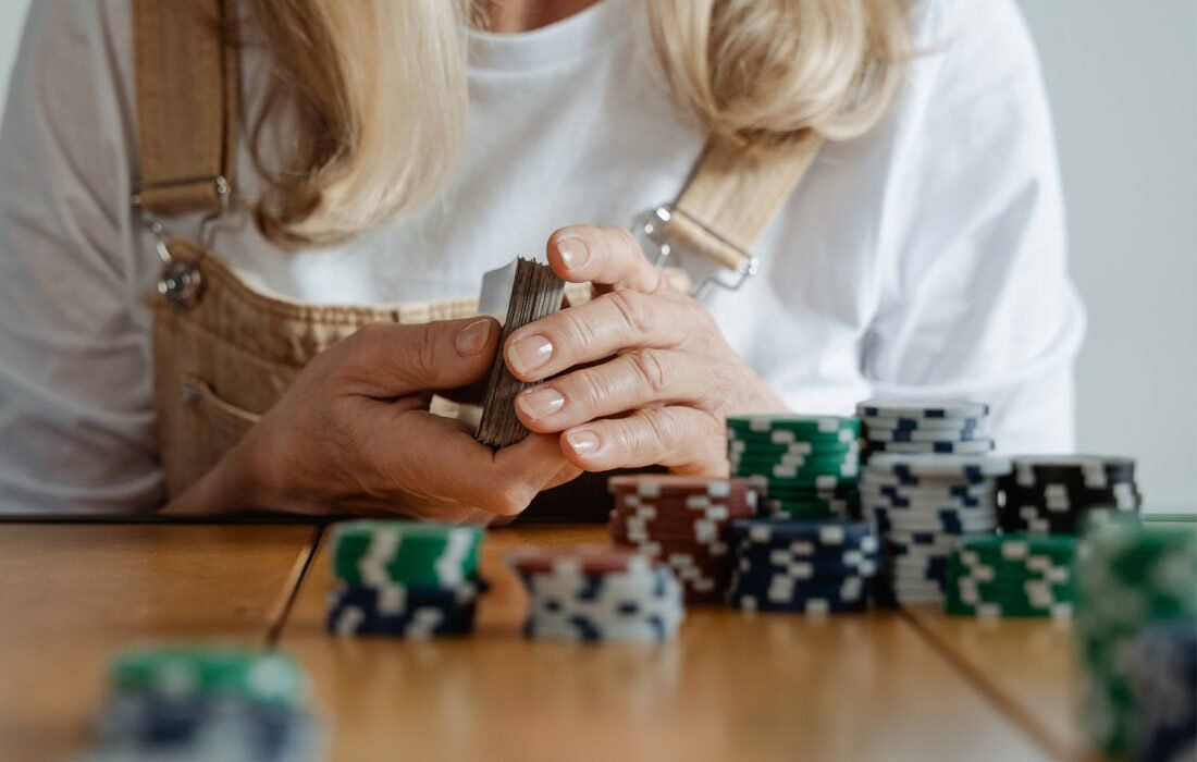 Woman is Sitting at a Table With a Pile of Poker Chips — MoneySmith Group In Kingscliff, NSW