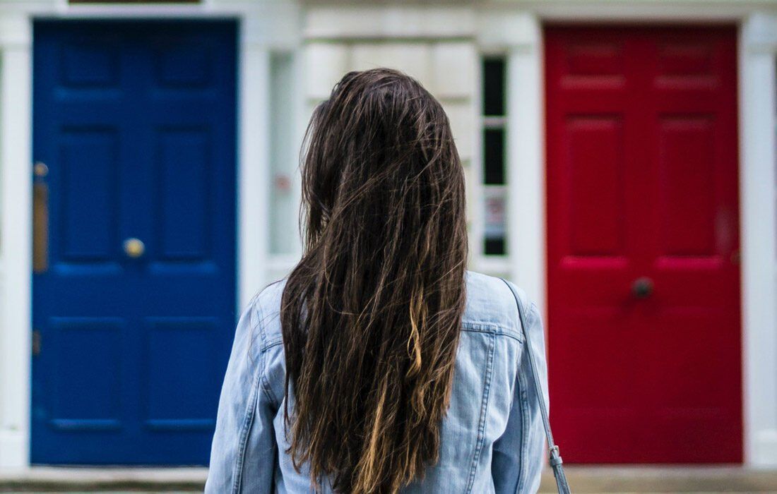 Woman is Standing in Front of a Door — MoneySmith Group In Kingscliff, NSW